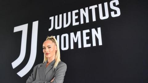 Alisha Lehmann posing in front of a Juventus badge