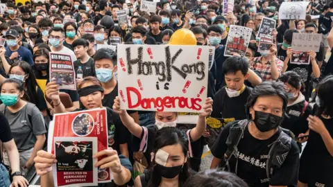 Getty Images Protesters occupy the arrival hall of the Hong Kong International Airport during a demonstration on 12 August