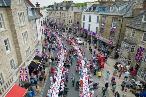 Getty Images Hundreds of people take part in Swanage's Jubilee street party