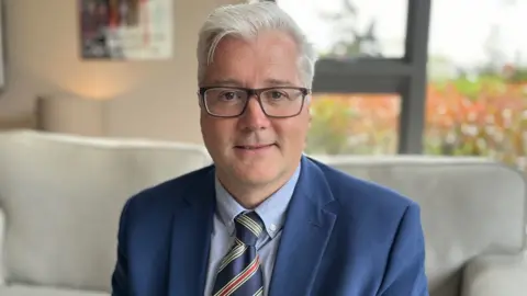 John Bishop, who was Lando Norris' 'house father' (head of house) at Millfield School in Somerset