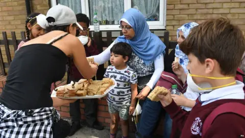 PA Woman handing out sandwiches to residents