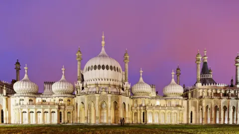 An English palace built in the style of Asian architecture. It's roof contains a series of large domes and spires. 