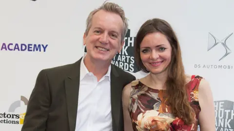 Getty Images Frank - whose real name is Christopher Collins - alongside long-term girlfriend Cath Mason