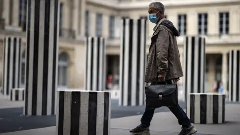 EPA man walks through paris art installation