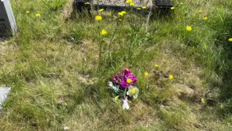 Family handout Flowers on baby's resting place