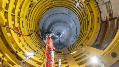 EDF A large yellow tube with a man standing in it