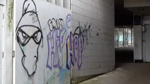 Grafitti on the walls of the derelict Crossways Shopping Centre in Paignton before it was demolished in April 2023