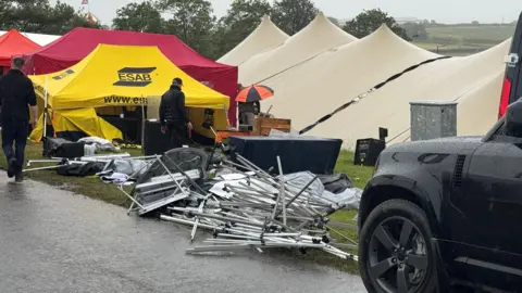 A view of the show ground, showing tents and a gazebo which has fallen. 