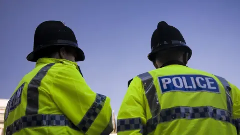 Getty Images Two police officers facing away from the camera