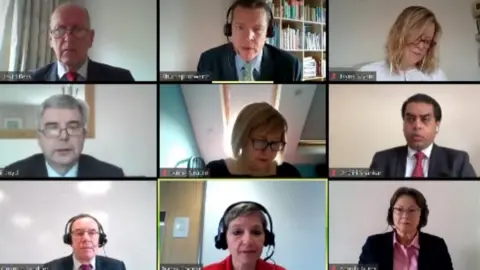 Senedd TV Tracey Cooper, bottom middle, is questioned by the committee