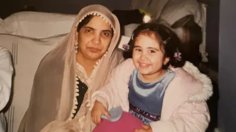 Angelina Aziz Angelina Aziz, as a child, with her grandmother