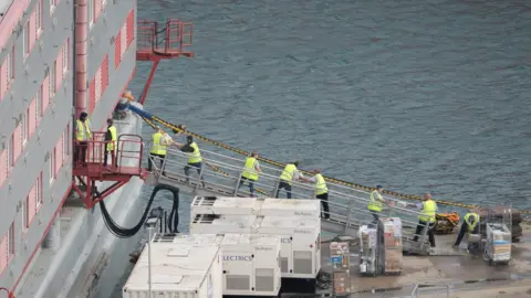 PA Media Food being loaded onto the ship on 2.8.23