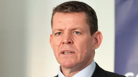 Rhun ap Iorwerth wearing a dark suit and a white shirt.