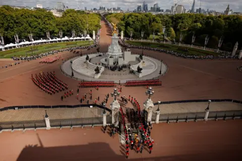 Getty Images King Charles III and members of the royal family behind Queen Elizabeth II's flag-draped coffin as it is taken in procession on a Gun Carriage of The King's Troop Royal Horse Artillery from Buckingham Palace to Westminster Hall