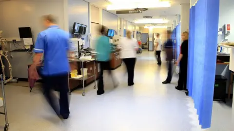 PA Media File photo of staff on a NHS hospital ward