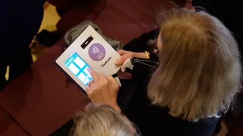 SumUp Image shows a contactless being made at a church