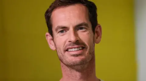 Getty Images Andy Murray, a man with brown hair smiling.