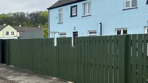 Fence with two bits cut out of the top
