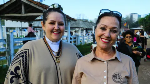 Claudia Matiello and Raquel Oliveira pose for a photo