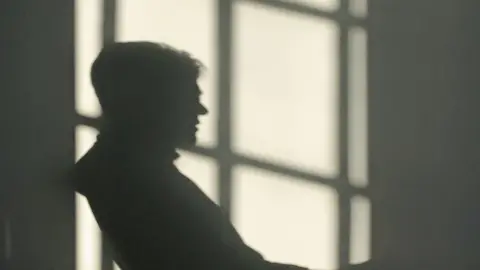 Illegal Money Lending Team Money Box interviewee in silhouette