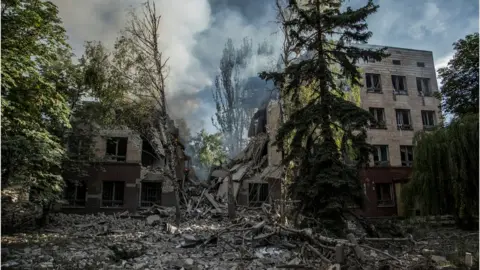 Reuters Smoke rises over the remains of a building destroyed by a military strike, as Russia's attack on Ukraine continues, in Lysychansk, Luhansk region, Ukraine June 17, 2022.