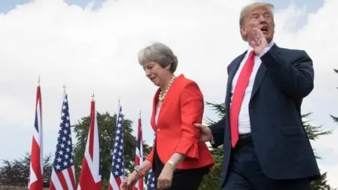 PA Donald Trump and Theresa May