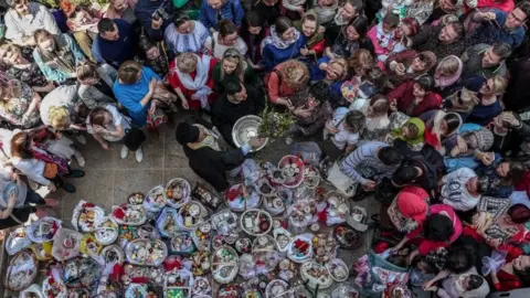 EPA A priest blesses Orthodox believers during an Easter ceremony at St George Church in Istanbul