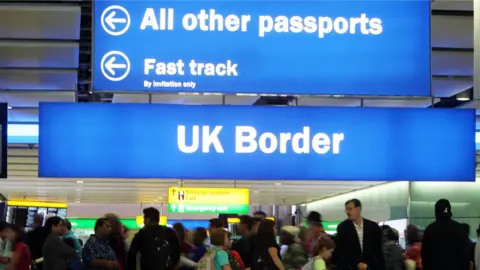 PA Border control signs at heathrow airport