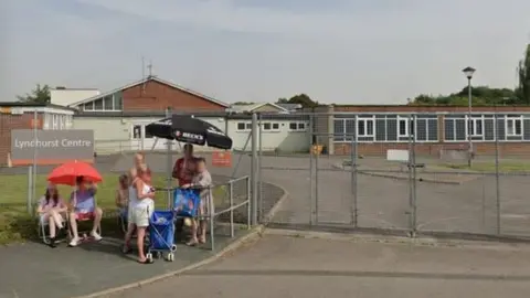 Maisie Lillywhite Google Maps image of the closed Lyndhurst Centre in Park North with people waiting outside the gates