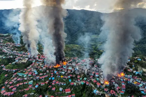AFP this aerial photo taken on October 29, 2021 show smokes and fires from Thantlang, in Chin State, where more than 160 buildings have been destroyed caused by shelling from Junta military troops, according to local media.