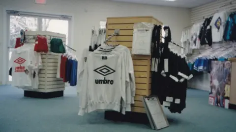 Judith Gates Old photo of Umbro jumpers on a rack in a sports shop