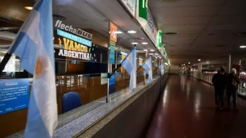 AFP Commuters walk at the closed Retiro bus terminal in Buenos Aires on June 25, 2018