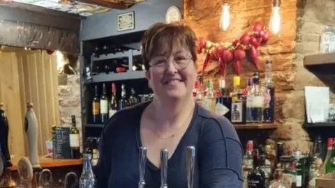 Lisa Pandy behind the bar