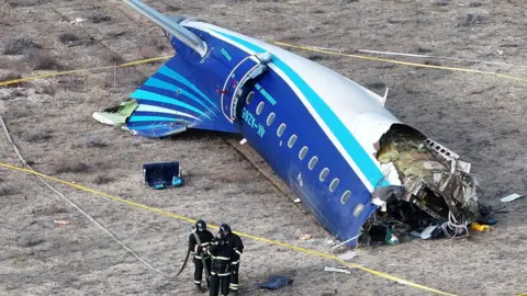 Reuters Emergency crews at the crash site of an Azerbaijan Airlines passenger plane near the city of Aktau, Kazakhstan, 25 December 2024