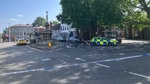 BBC Street view of St Mary's Butt in Reading with two police cars and police tape to cordon off the road.