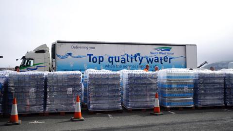 A lorry with pallets of water bottles