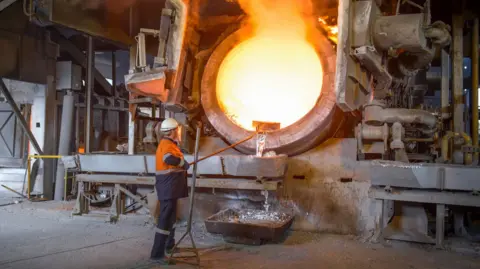 Getty Images Worker at an aluminium recycling plant