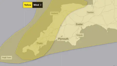 Met Office A map of Devon and Cornwall. There are grey boxes with High Town, Truro, Hartland, Plymouth, Exeter, Torquay and Taunton written in them. There is are two yellow shapes over Devon and Cornwall. With a yellow and black box that says "Yellow" and "Wind" in the top left.