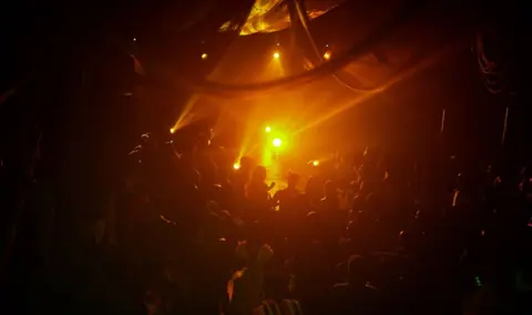 Demola Mako / The Fola Francis Ball People dance in yellow light