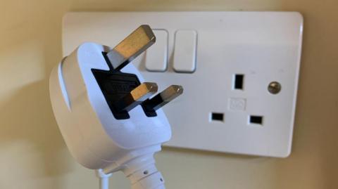 Plug in front of a socket