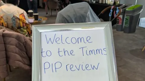Claire Harvey A photo of the sign as you enter the charity event which says 'welcome to the Timms PIP review.