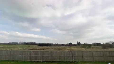 Where the former Whitwell Main Colliery was in Streethouse. Picture shows empty field and the fence of someone's back garden.