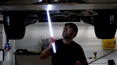 Reuters An engineer works below a Range Rover PHEV (Plug In Hybrid Electric Vehicle) at the new Jaguar Land Rover electric vehicle test centre in Whitley