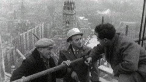 John Morgan interviewing two Irish workers on scaffolding at the top of Westminster Cathedral.