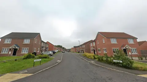 Google Streetview of Frosterley Drive. It is a street of two-storey houses, mixture of detached and semi-detached, made from red brick.