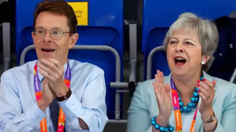 Getty Images Andy Street (left) with Theresa May at the Commonwealth Games 