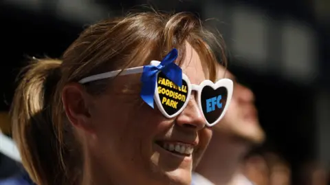 Reuters An female Everton fan's glasses displays a "farewell Goodison Park" message 