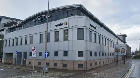 Petrofac building in Aberdeen. It is a large white building on the corner of the street.