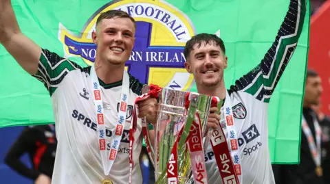 Daniel Ballard and Trai Hume celebrate winning promotion to the Premier League
