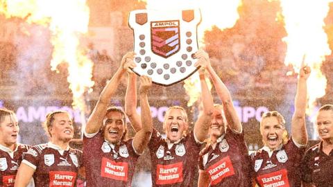 Queensland's players celebrate winning the 2024 State of Origin match
